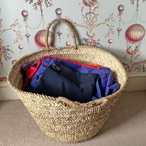 Berber storage basket with clothes in a bedroom