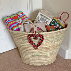 Rope handle basket filled with Christmas gifts