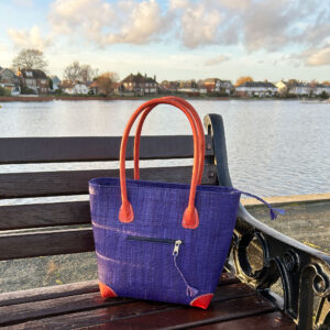 Vero raffia handbag in navy on a bench