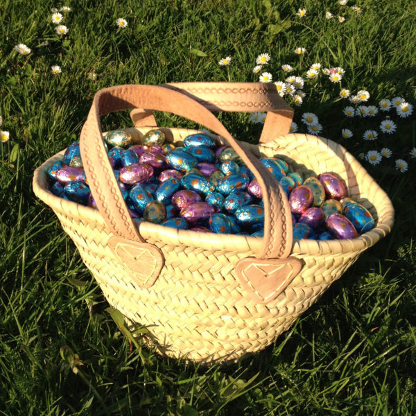 Baby french basket filled with mini chocolate eggs for Easter