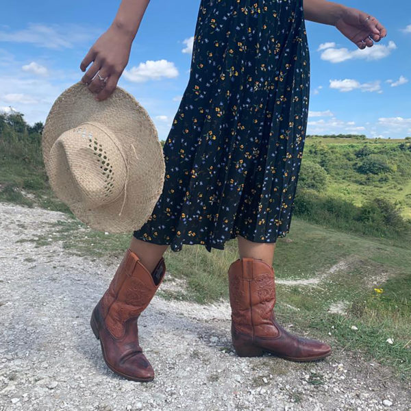 Cowboy Raffia Hat modelled with cowboy boots at picnic