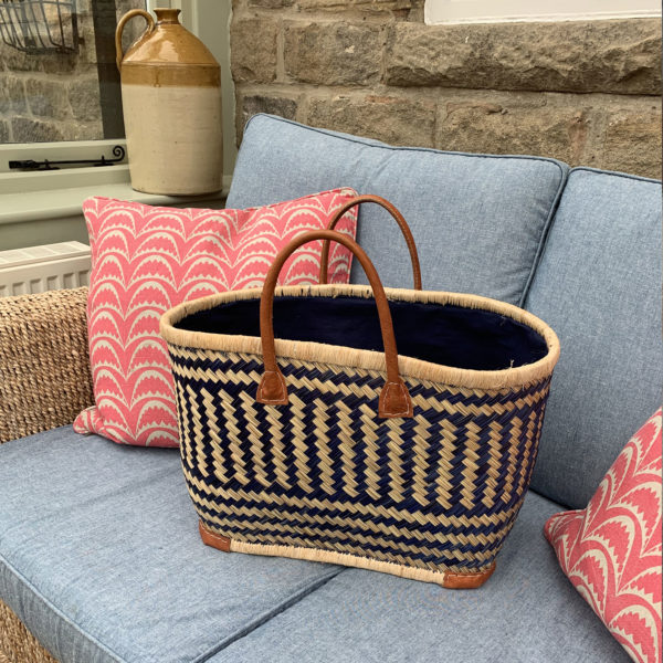 Large blue drawstring shopper basket in conservatory