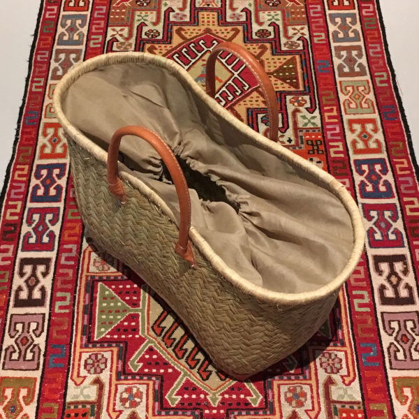 Large natural drawstring shopper basket on patterned rug