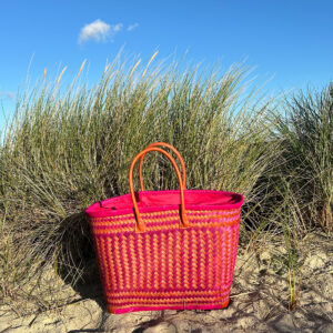 Large drawstring shopper in orange and pink at the beach