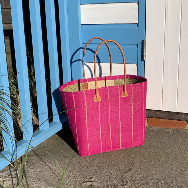 Large pink pinstripe basket bag by beach hut