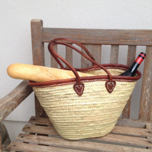 Leather trim French market basket with wine bottle and baguette