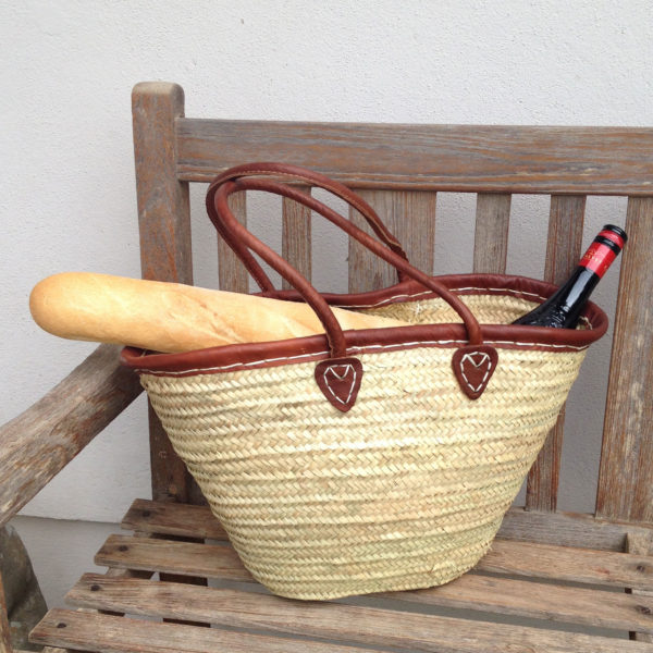 Leather trim French market basket with wine bottle and baguette
