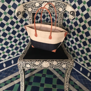 Natural and black mery zip handbag on Moroccan chair