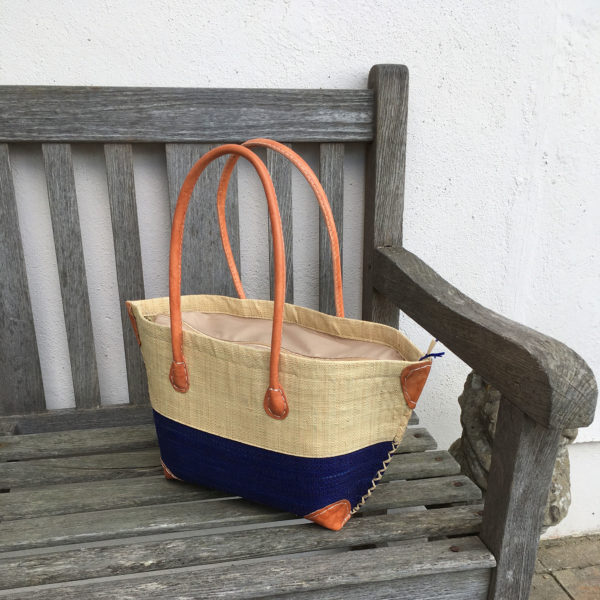 Natural and navy mery zip handbag on bench