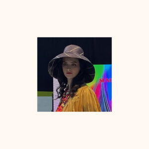 Black pinstripe mimosa hat being worn by model at Moda Fashion Show