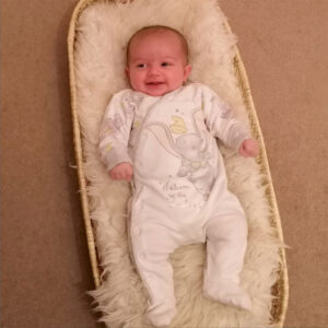 11 week old baby in palm leaf woven baby changer basket