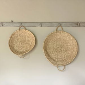 Medium and large round palm trays hanging on wall