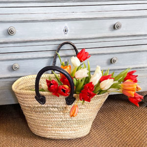 Short navy handle French basket filled with tulips
