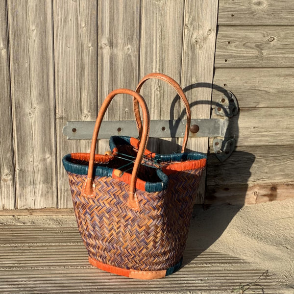 Small orange and blue bosaka basket bag at wooden beach hut
