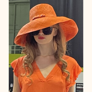 Orange mimosa hat being modelled at Moda Exhibition cat walk in February 2023