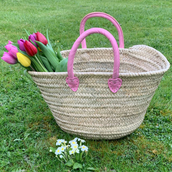 Small pink handle basket with spring tulips