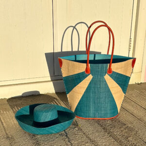 Turquoise sunburst raffia tote bag with matching mimosa hat at beach