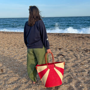 Sunburst bag in red at sunset on a beach