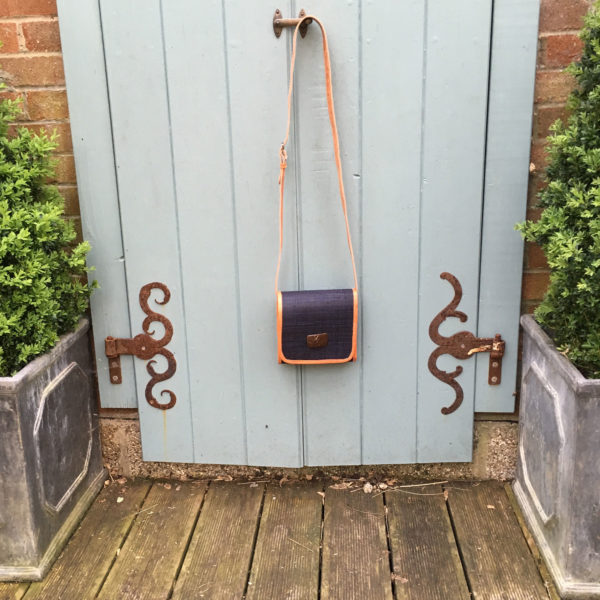 Black tiana handbag hanging on door