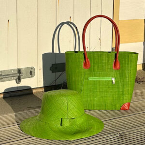 Vero Handbag and Amelie Hat in lime green by a beach hut