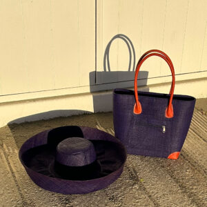 Vero Handbag and Large Mimosa Hat in navy by a beach hut