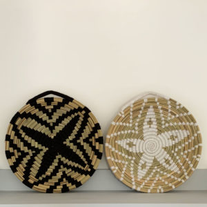 Black and white wool and straw woven plates on wall