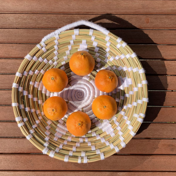 White wool and straw plate with oranges