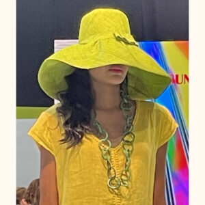 Lime large mimosa hat being modelled at Moda Exhibition cat walk in February 2023