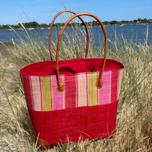 large Hanta Stripe Basket Bag in red beside the sea