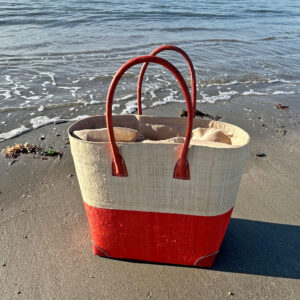 Large Hanta Two Tone Tote Bag in natural and coral colours beside the sea