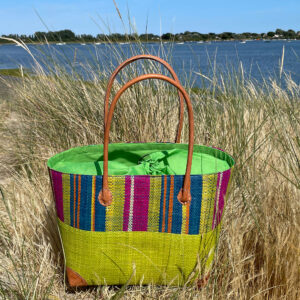 Medium Hanta Stripe Basket Bag in lime green beside the sea