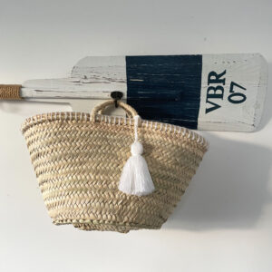 Little Basket with a white tassel hanging on an oar