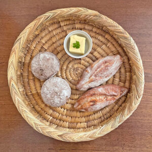 Round plate tray with butter and bread rolls