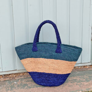 Crochet bucket bag in blues at the beach