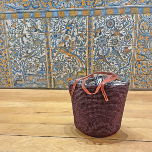 Crochet bucket bag in brown beside tiles in Lisbon, Portugal