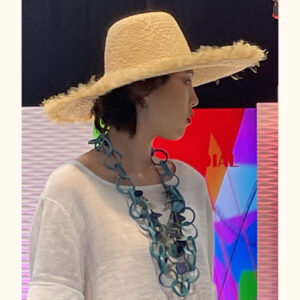 Natural frayed raffia wide brim hat being modelled at Moda Exhibition cat walk in February 2023