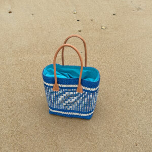 Medium size turquoise diamond sisal basket bag at the beach