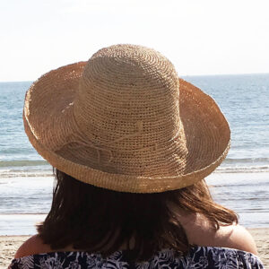 Mimosa Crochet Raffia Sun Hat on model at beach
