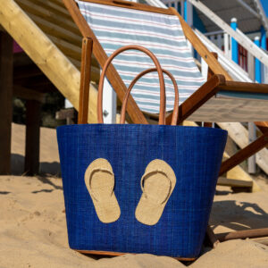 Navy Flipflop Beach Bag beside a deck chair on a beach