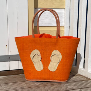 Orange Flipflop Beach Bag beside a beach hut