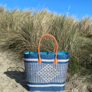 Large turquoise sisal basket bag at the seaside