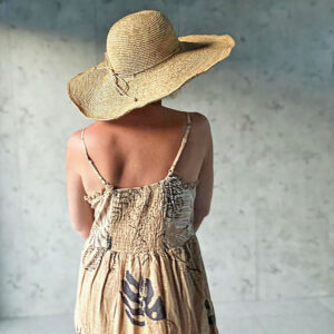 Model wearing wide brim crochet hat in a sun dress