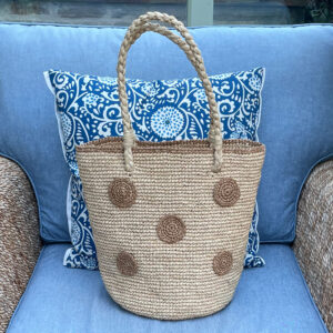 Crochet circles bag in tea colour on a chair in a conservatory