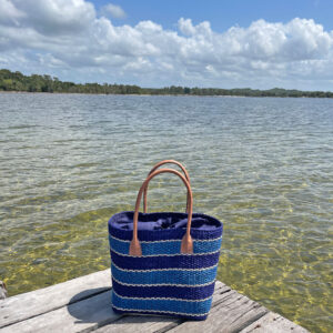 Blues sisal striped tote bag on jetty beside lake in Madagascar