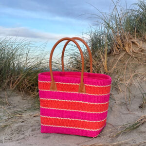 Orange and pink sisal striped tote bag at a beach