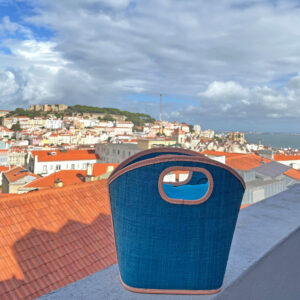 Toky Handbag in turquoise on balcony overlooking Lisbon, Portugal