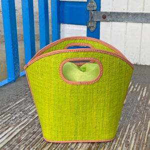 Toky raffia handbag in lime green at a beach hut