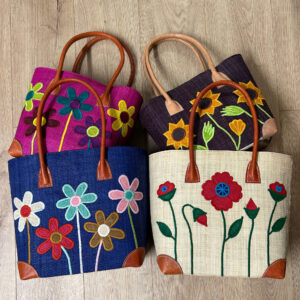 Two mixed sets of embroidered tote bags
