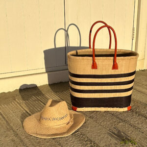 Medium black porto stripe raffia bag with a raffia cowboy hat at the beach