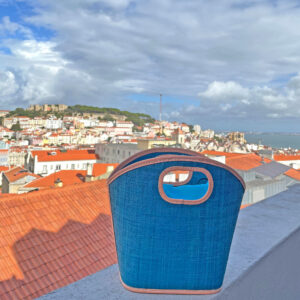 Toky Handbag in turquoise on balcony overlooking Lisbon, Portugal